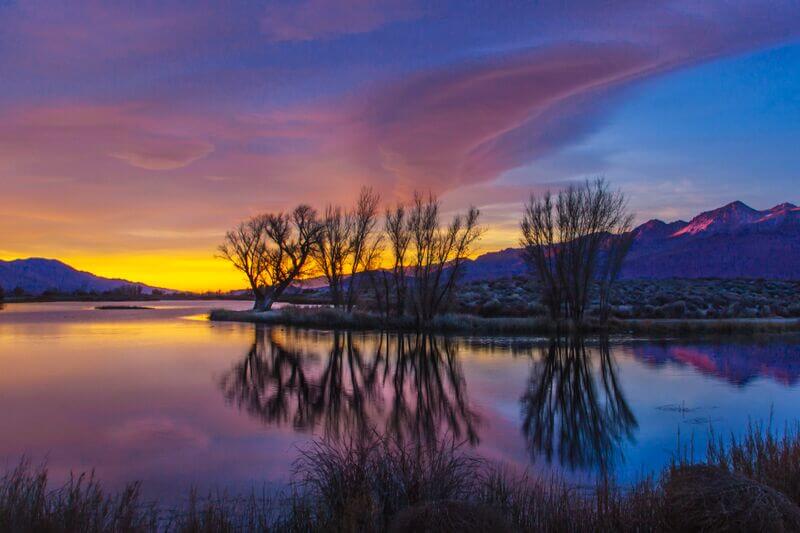 Sunset with Pink Yellow and Blue Clouds over Farmer's Pond in Bishop California
